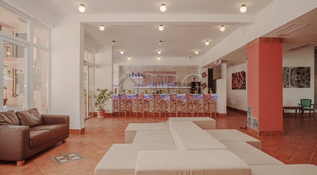 Modern lobby with comfortable seating and a reception desk in a new apartment building.