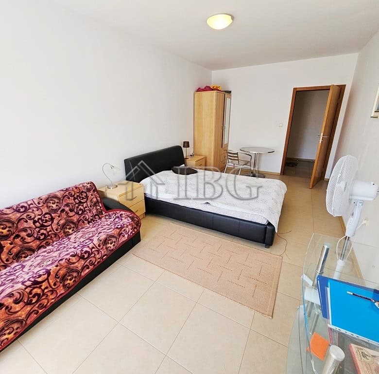 Interior of a 2-bedroom apartment with pool and sunny beach views, bright and spacious living area.