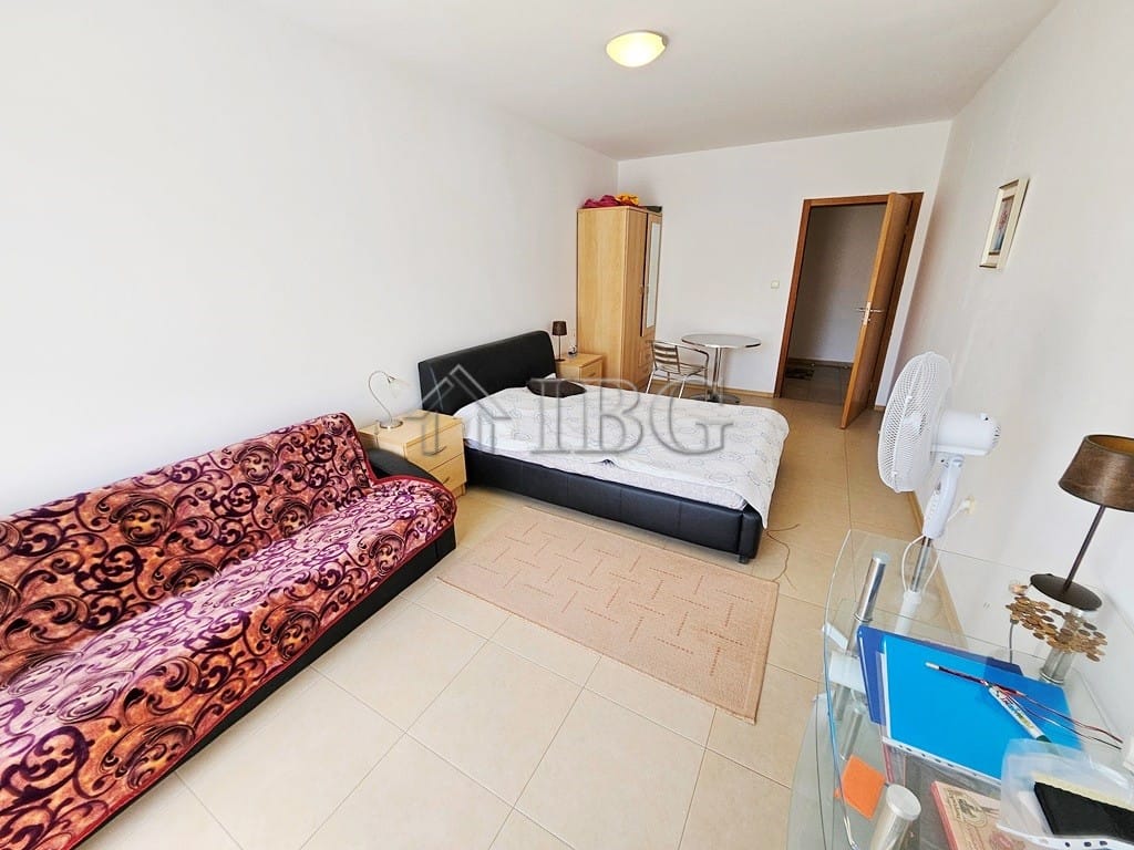 Interior of a 2-bedroom apartment with pool and sunny beach views, bright and spacious living area.