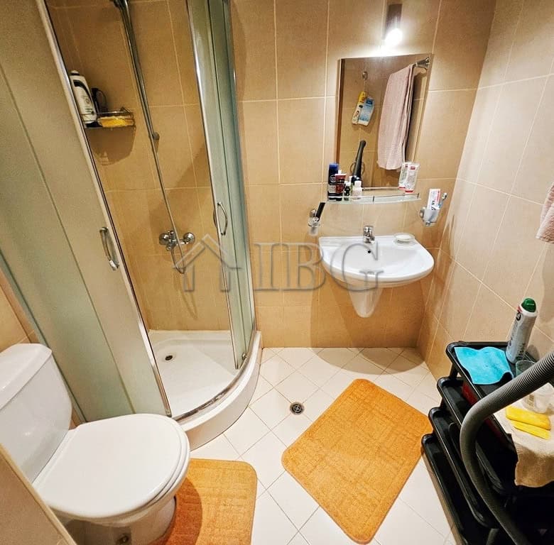 Cozy bathroom with shower, sink, and toilet in a modern apartment.