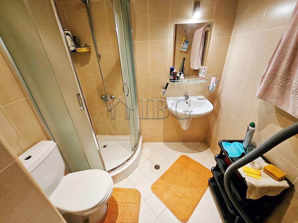 Cozy bathroom with shower, sink, and toilet in a modern apartment.
