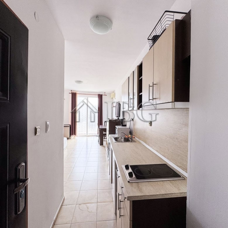 Compact studio apartment with pool view and modern kitchen. Perfect for a sunny beach getaway.