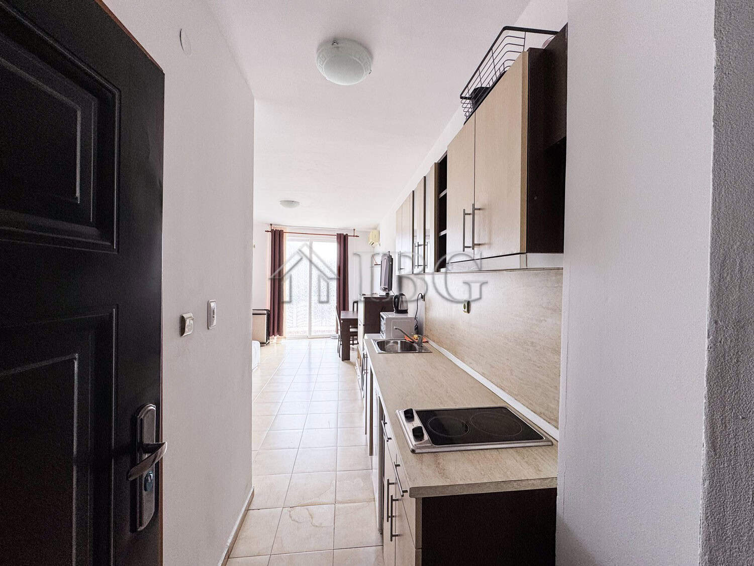 Compact studio apartment with pool view and modern kitchen. Perfect for a sunny beach getaway.