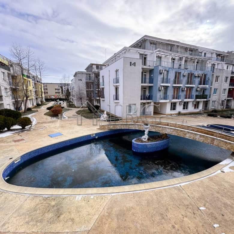 Charming studio apartment overlooking a serene pool on a sunny day at Sunny Beach.