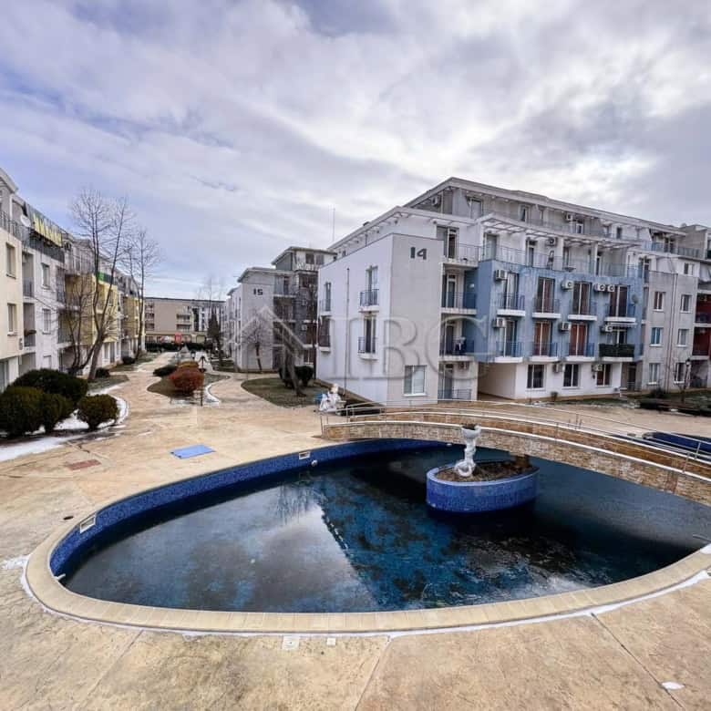 Pool view of a cozy studio apartment in a modern residential complex.