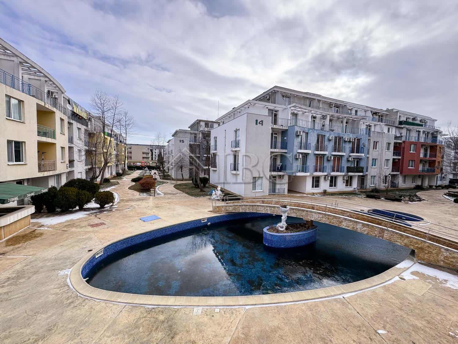 Pool view of a cozy studio apartment in a modern residential complex.