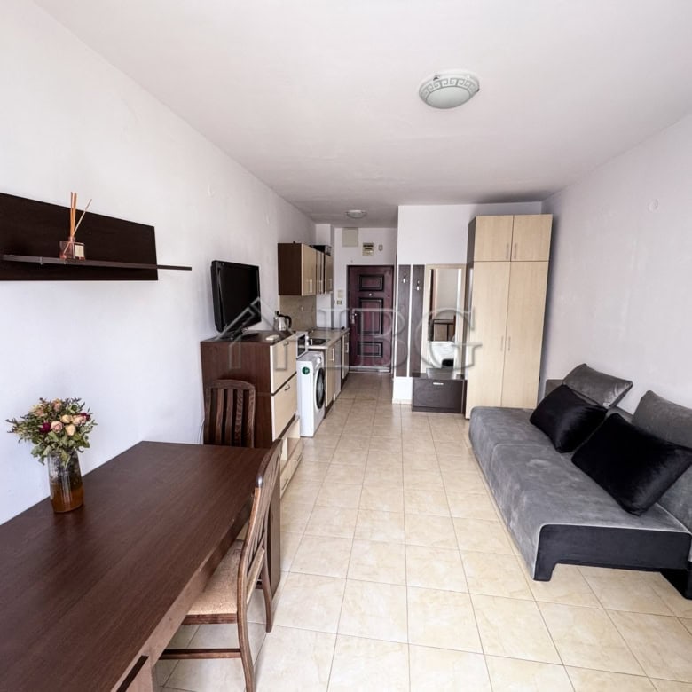 Interior of a cozy studio apartment with pool view, modern furnishings, and bright decor in Sunny Be.