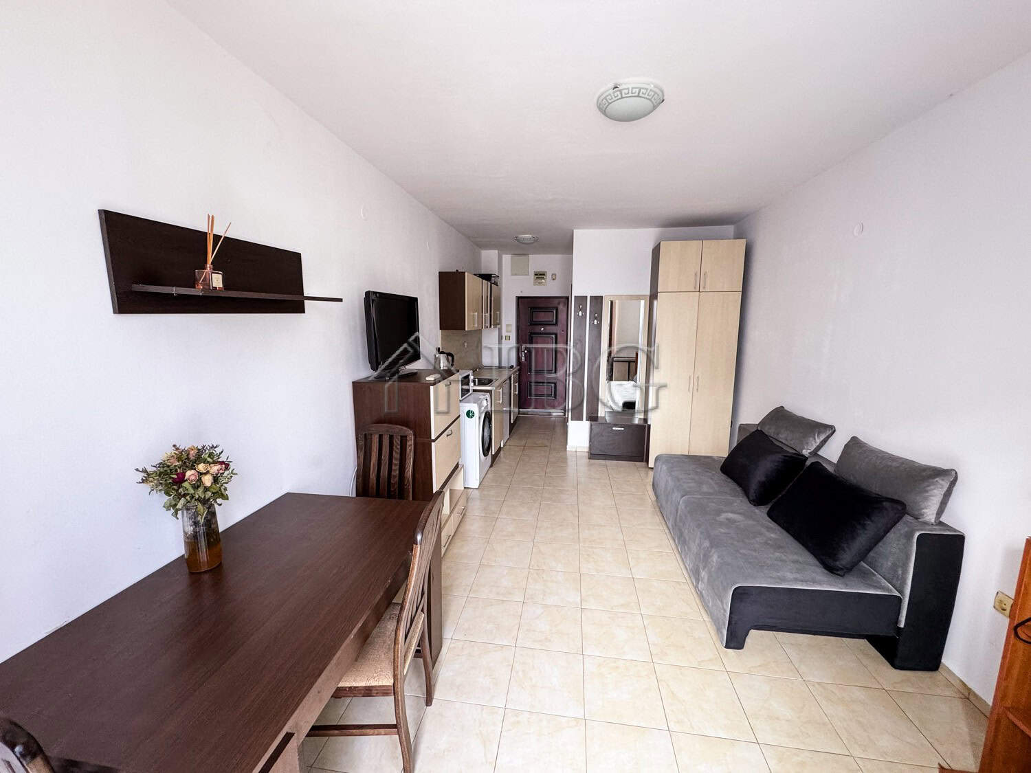 Interior of a cozy studio apartment with pool view, modern furnishings, and bright decor in Sunny Be.
