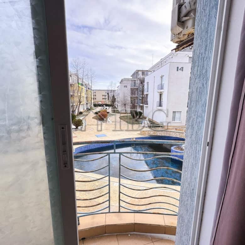 Cozy studio apartment overlooking a swimming pool on a sunny day at Sunny Beach.