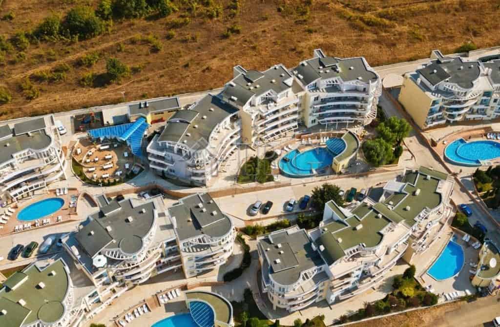 Aerial view of Sunset Kosharitsa showing one-bedroom apartments with garden access and swimming pool.