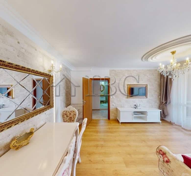 Bright living room of a one-bedroom apartment in Sunny Beach with elegant decor and large windows.