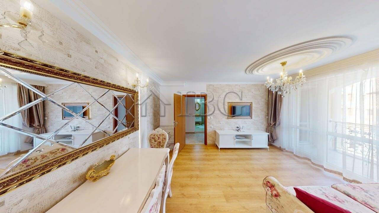 Bright living room of a one-bedroom apartment in Sunny Beach with elegant decor and large windows.
