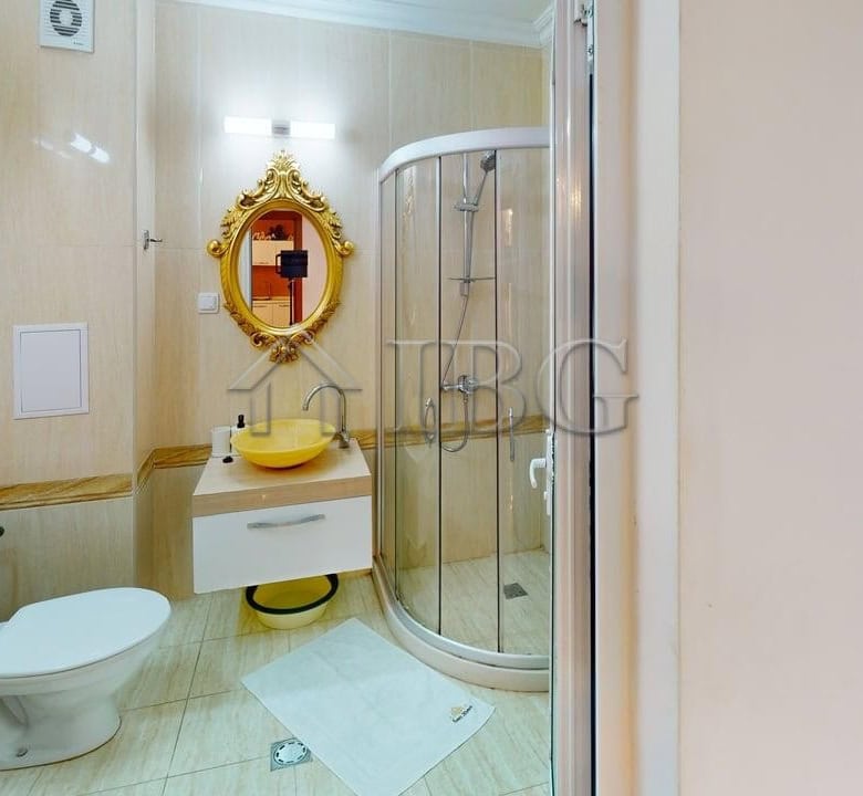 Bright bathroom with shower, toilet, and stylish decor.