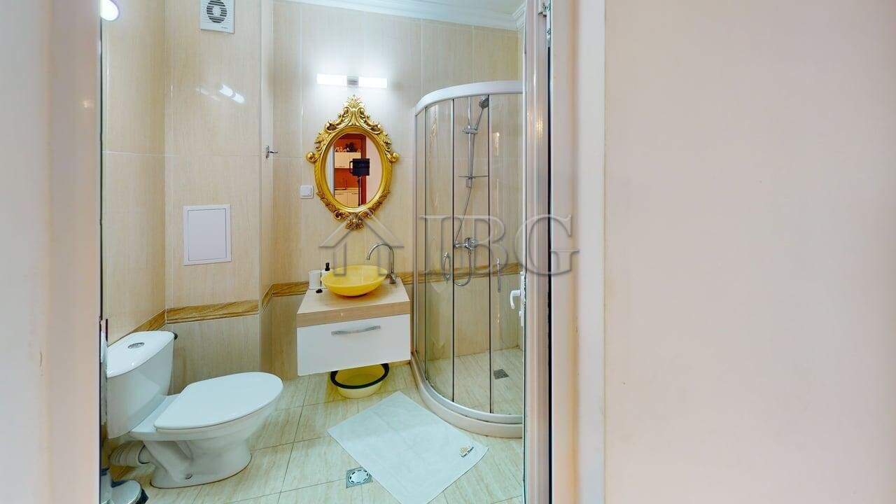 Bright bathroom with shower, toilet, and stylish decor.