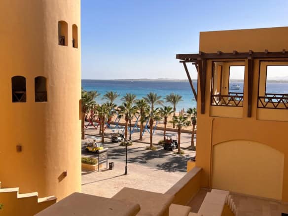 Beautiful seaside view with palm trees and ocean backdrop.