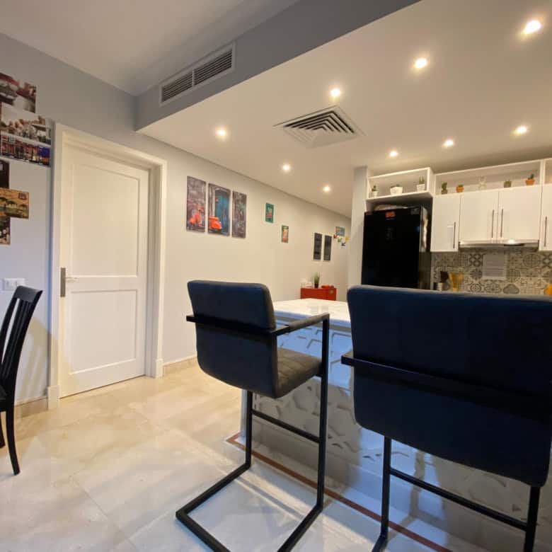 Modern kitchen and dining area with stylish furniture and decor.