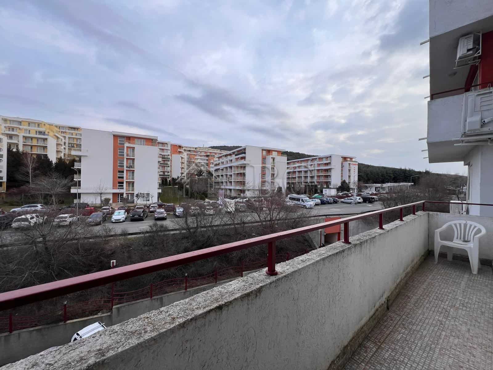Bright balcony overlooking Sveti Vlas marina and surrounding residential buildings.