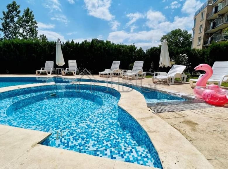 Pool area with sun loungers and umbrellas at VIP Zone Complex, Sunny Beach.