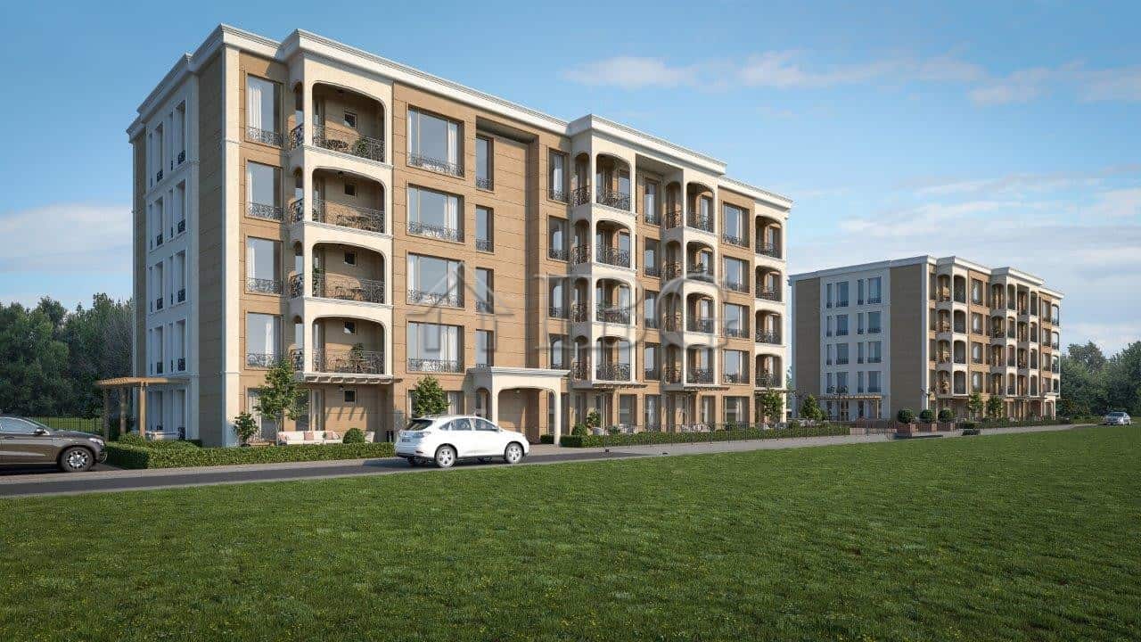 Modern residential building in Nessebar with spacious balconies and green surroundings.