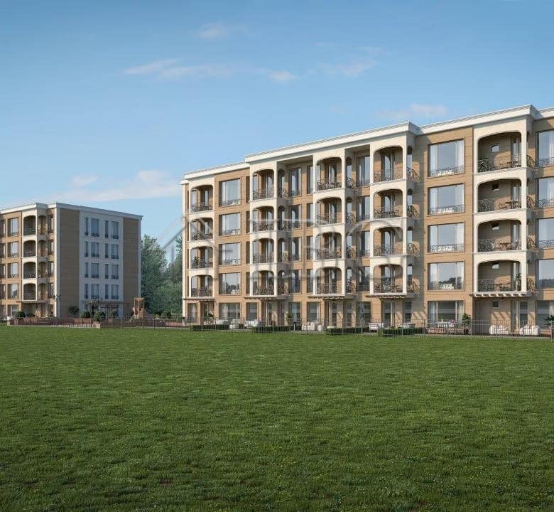Modern residential complex in Nessebar with spacious balconies and green surroundings.