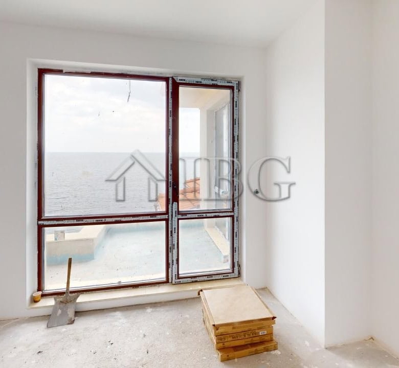 Bright room with large sea view window in a new apartment under construction.