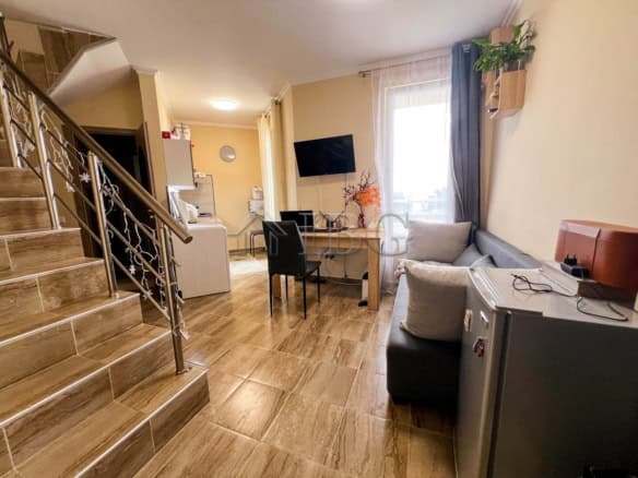 Modern 1-bedroom apartment with pool view in Sunny Beach, featuring a living area and balcony.