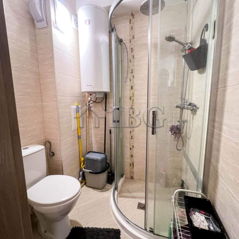 Apartment with modern shower and compact bathroom space.