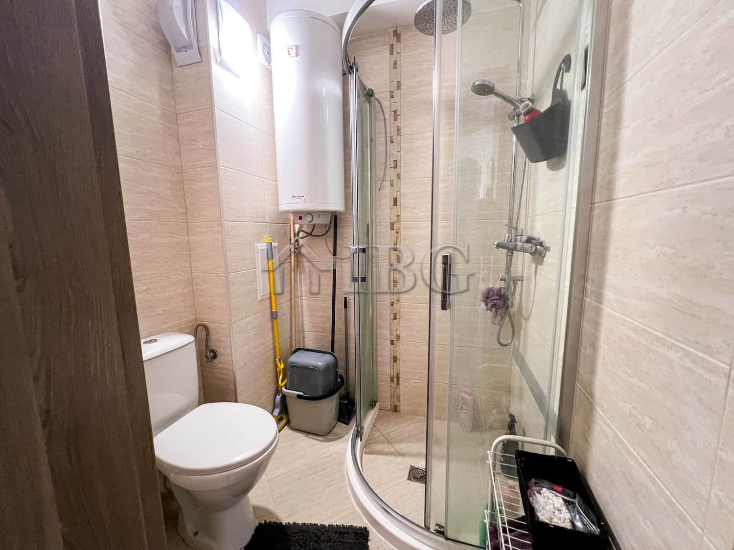 Apartment with modern shower and compact bathroom space.