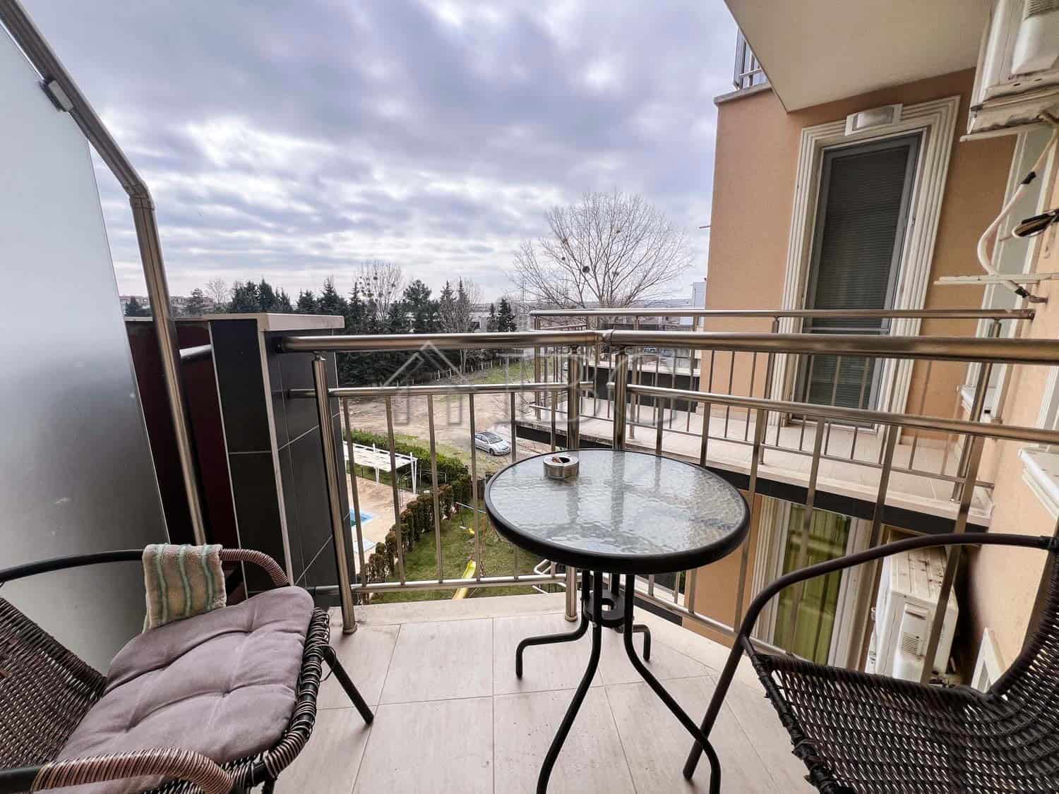 Balcony view of pool and surrounding area in Sunny Beach apartment.