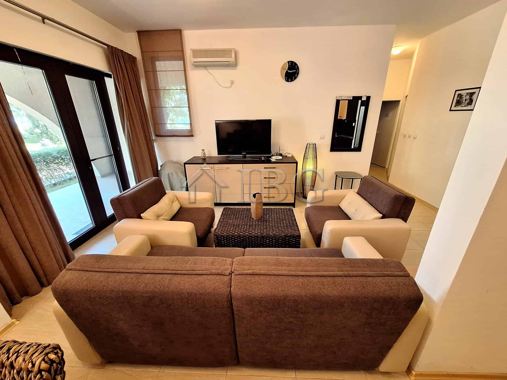 Bright living room with modern furniture and large windows overlooking the sea. Perfect beachfront p.
