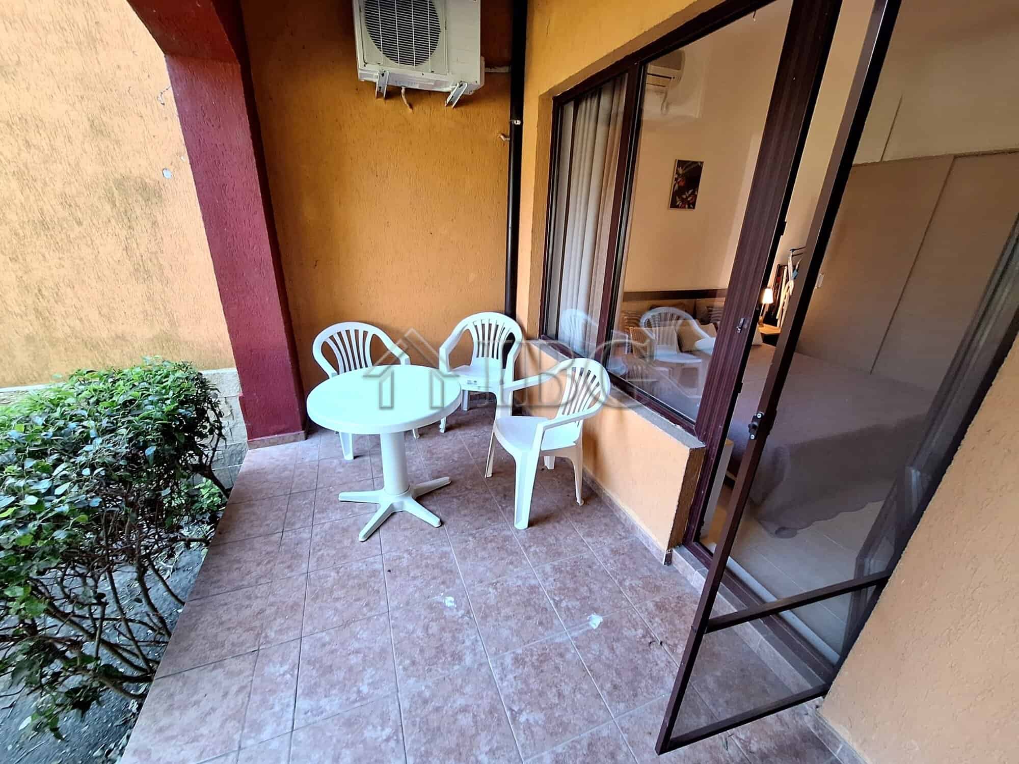 Bright veranda with outdoor seating and garden view.