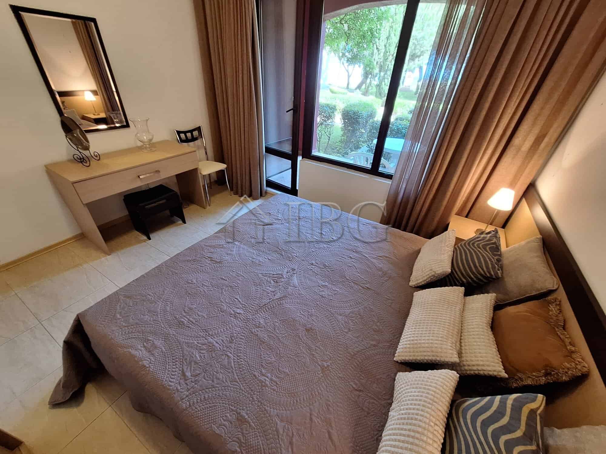 Spacious bedroom featuring a large window with garden and sea views, perfect for relaxing and enjoyi.