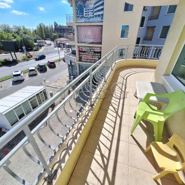 Balcony with two colorful chairs overlooking Sunny Beach streets and surrounding buildings.