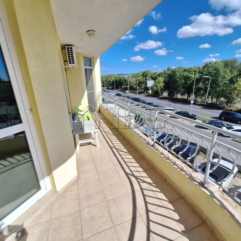 Bright balcony overlooking pool and greenery in Breeze complex, Sunny Beach.