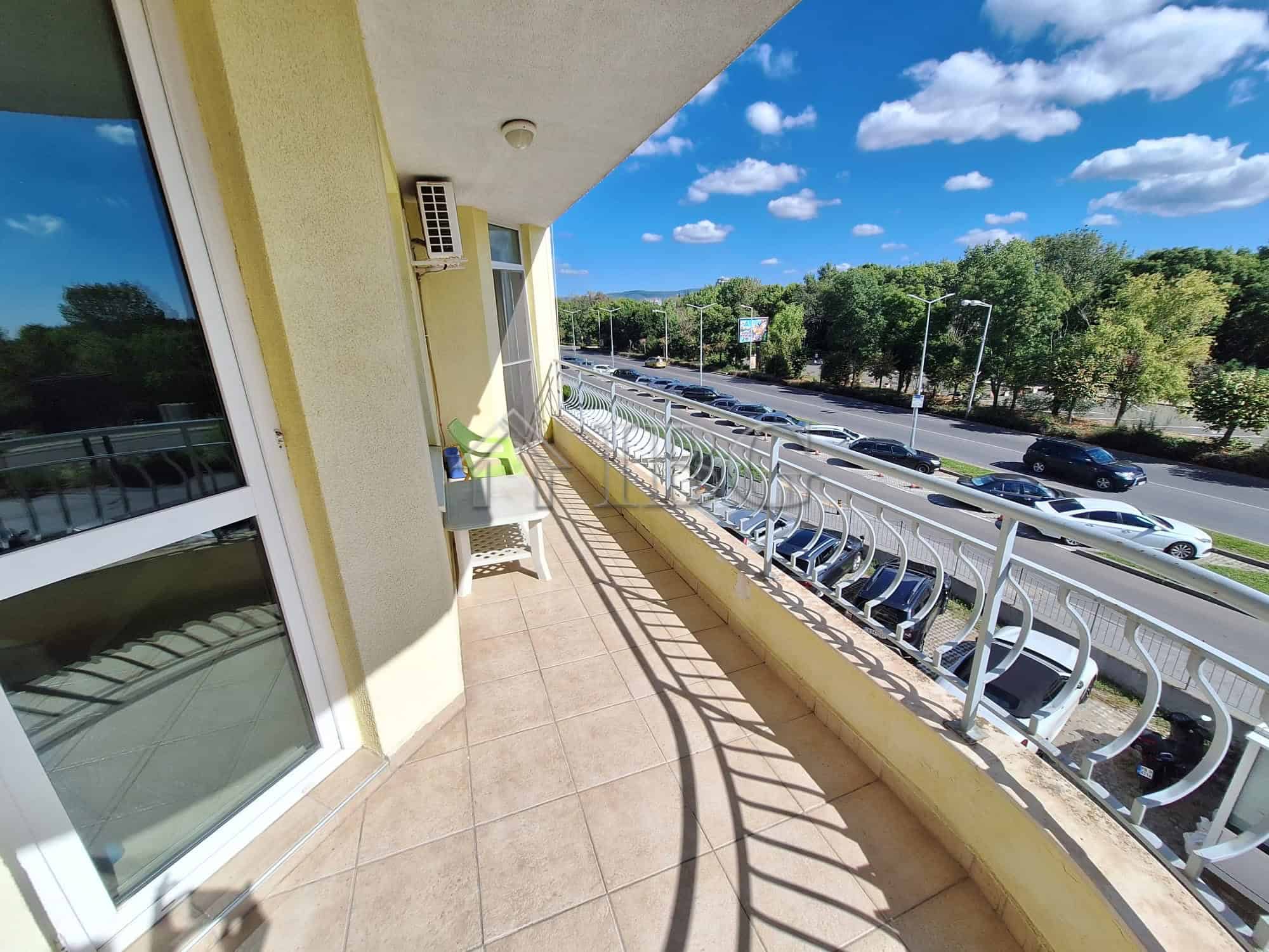 Bright balcony overlooking pool and greenery in Breeze complex, Sunny Beach.