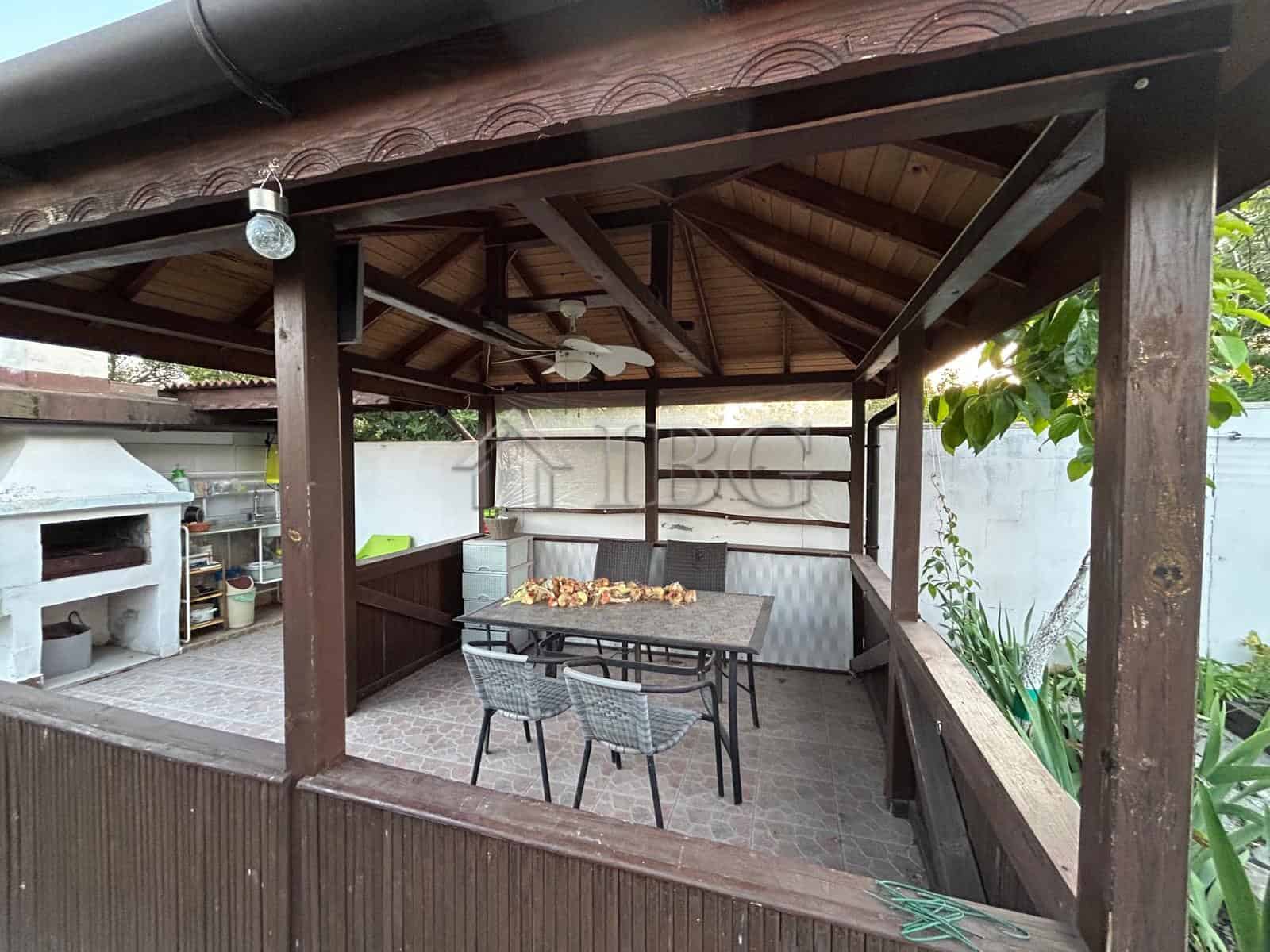 Outdoor dining space with seating in a renovated house near the sea in Kamenar district.