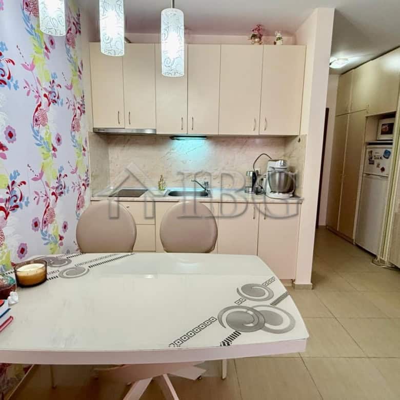 Bright kitchen with modern appliances and a cozy dining space in a spacious Nessebar apartment.