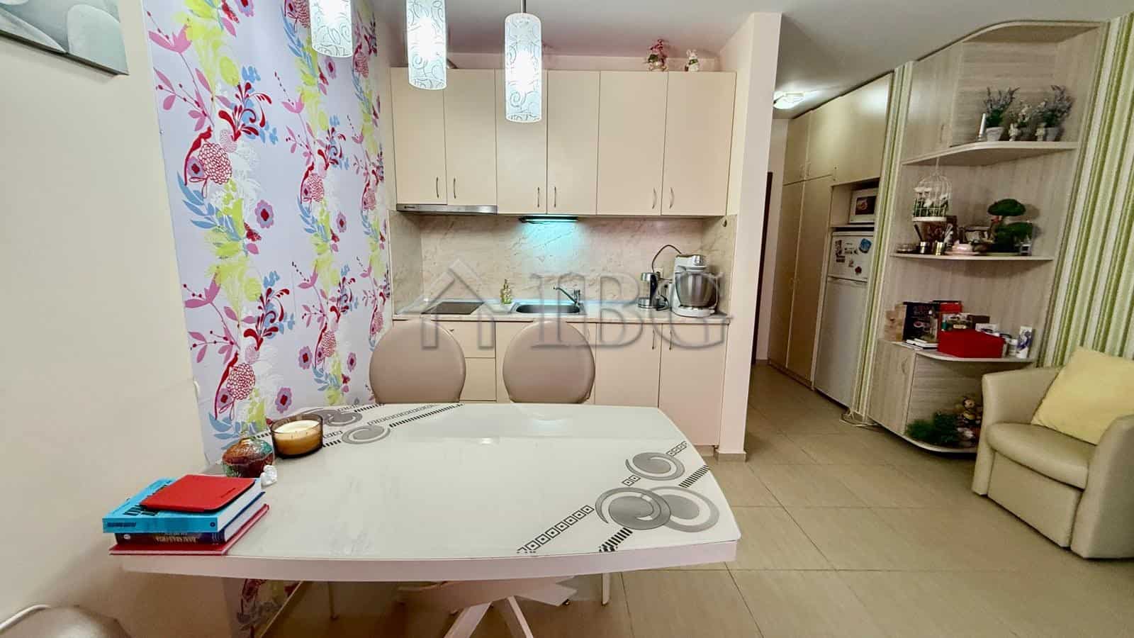 Bright kitchen with modern appliances and a cozy dining space in a spacious Nessebar apartment.