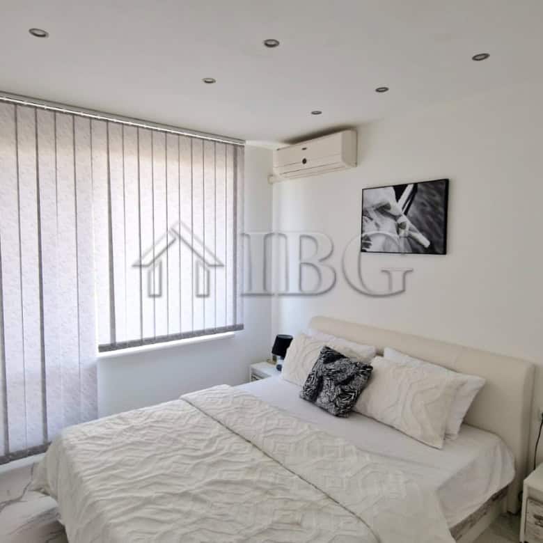 Bright bedroom with sea view, large terrace, and modern decor in Sveti Vlas apartment.