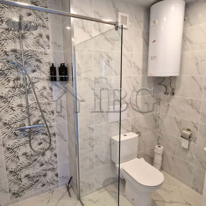 Bright bathroom with modern fixtures and sea view from the terrace.
