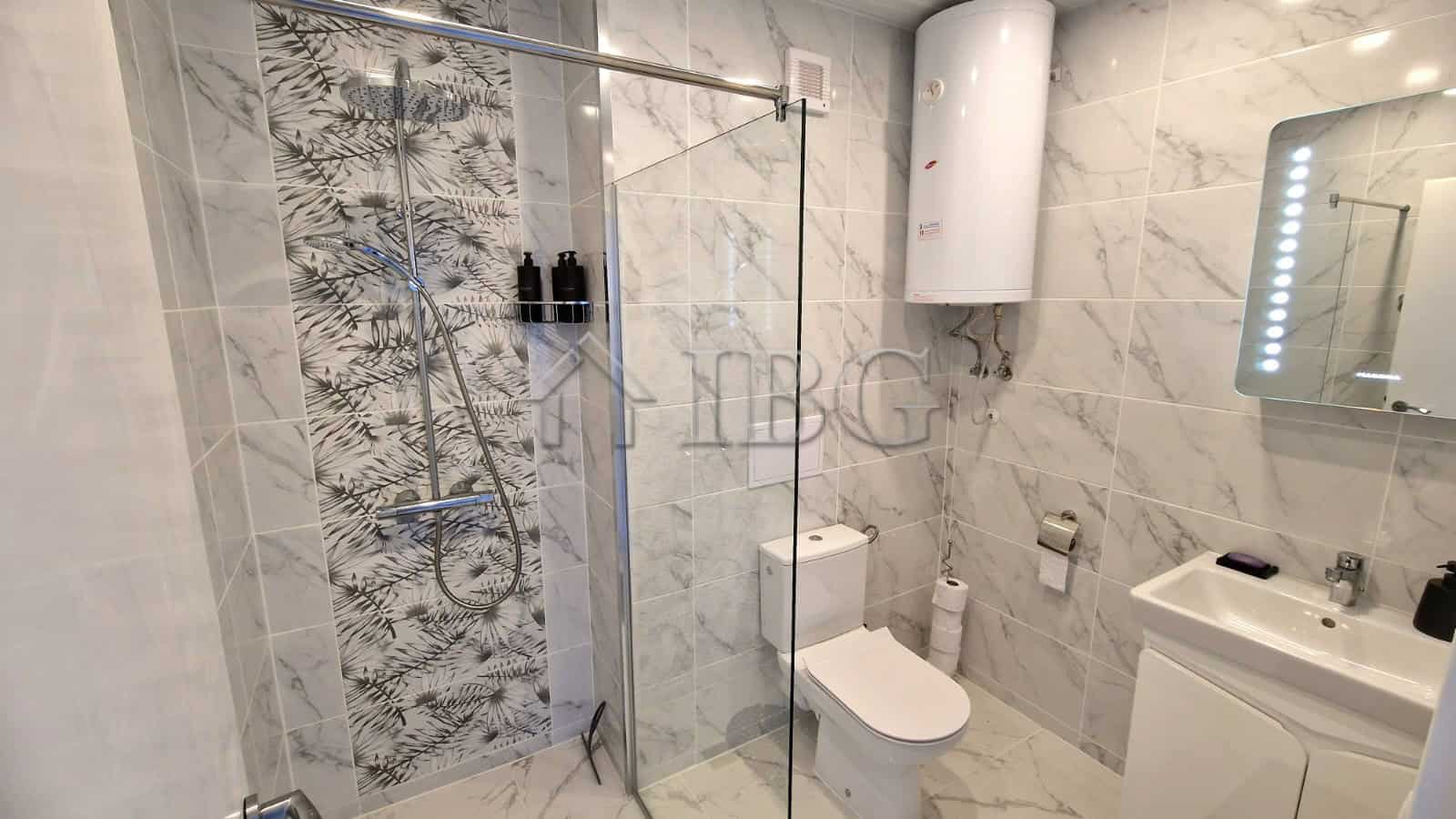 Bright bathroom with modern fixtures and sea view from the terrace.