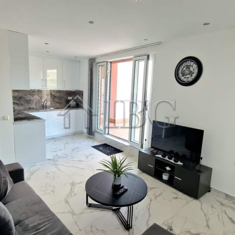 Bright living room with sea view, balcony access, and contemporary decor.