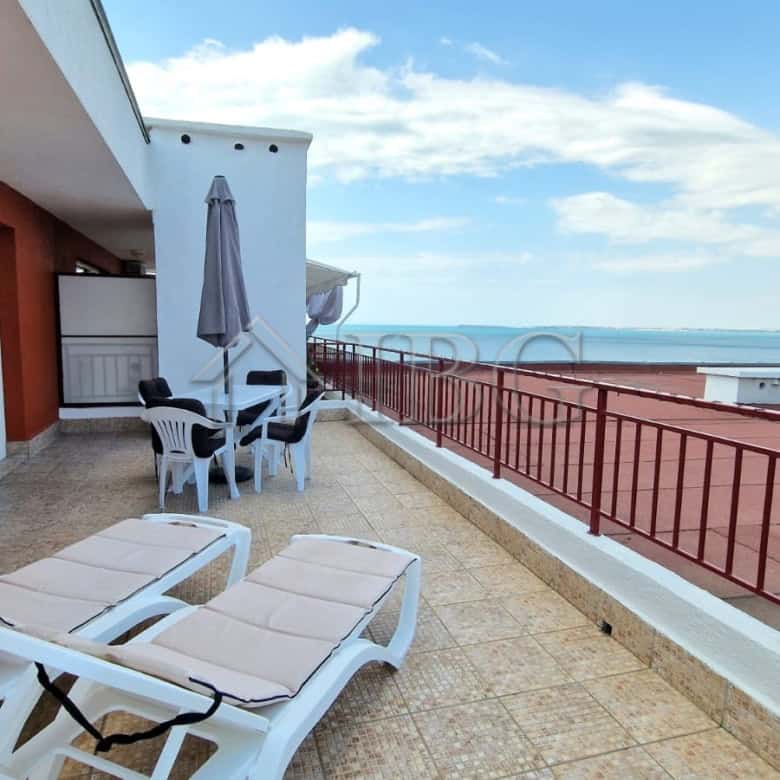 Sea view terrace of renovated apartment with outdoor furniture.