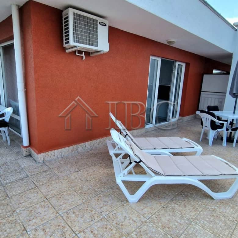 Large terrace with sea view, sun loungers, and outdoor dining area in Sveti Vlas.