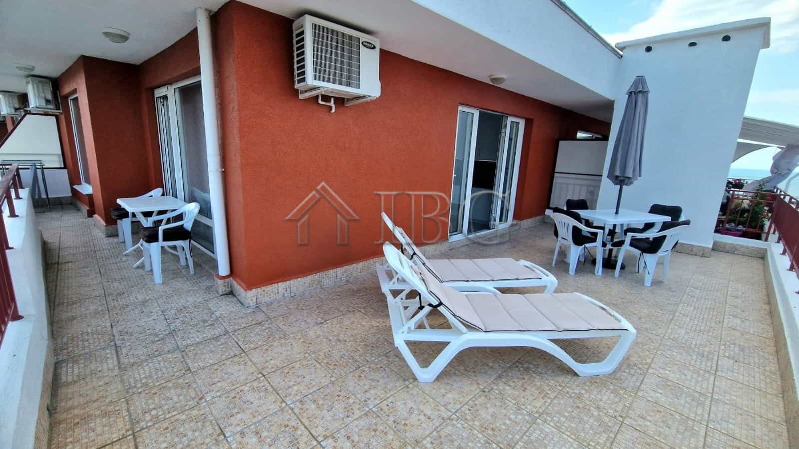 Large terrace with sea view, sun loungers, and outdoor dining area in Sveti Vlas.