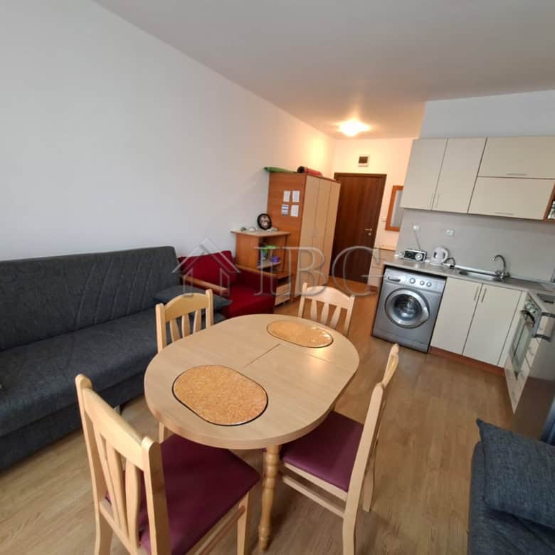 Modern furnished studio apartment with open-plan kitchen and dining area in Sunny Beach.