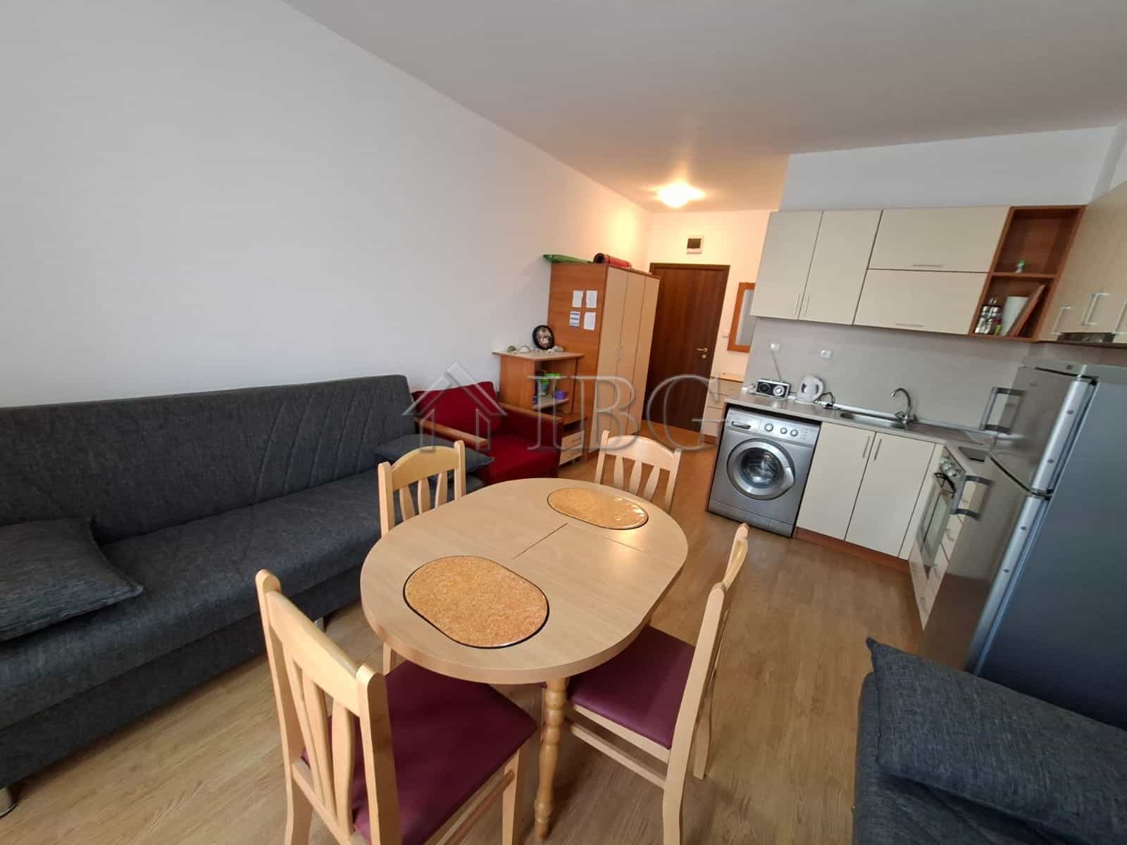 Modern furnished studio apartment with open-plan kitchen and dining area in Sunny Beach.