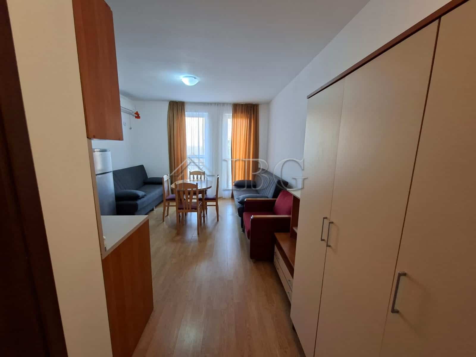 Furnished studio apartment with living area, sofa, dining table, and balcony in Sunny Beach.
