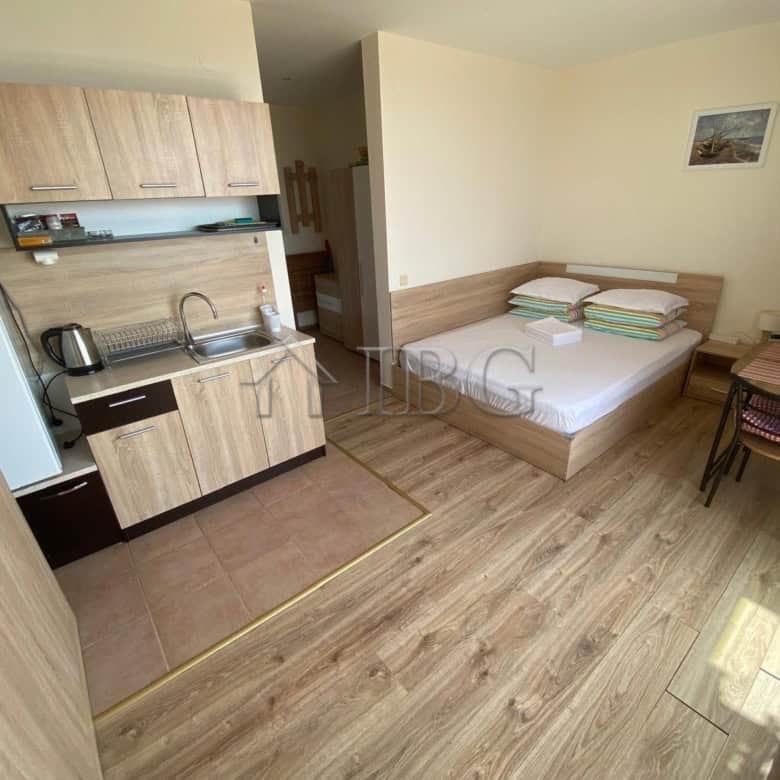 Cozy studio apartment with sea view, kitchenette, and sleeping area at Crown Fort Club.