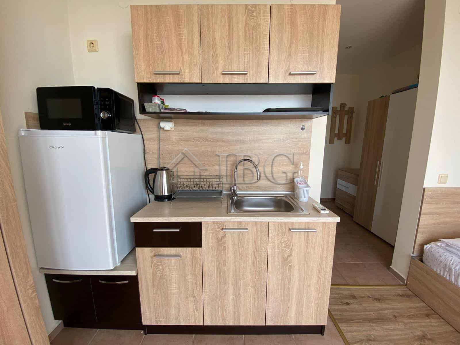 Studio with Sea View Kitchen | Crown Fort Club Compact studio kitchen with sea view, microwave, and fridge at Crown Fort Club.